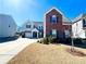 Two-story home with brick and siding exterior, a two-car garage, and a well-maintained lawn and garden at 9677 Garamont Nw Pkwy, Concord, NC 28027