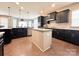Spacious kitchen featuring stainless steel appliances, dark cabinets, granite countertops and a center island at 9677 Garamont Nw Pkwy, Concord, NC 28027