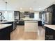 Spacious kitchen featuring stainless steel appliances, dark cabinets, and center island with granite countertops at 9677 Garamont Nw Pkwy, Concord, NC 28027