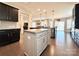Open kitchen featuring granite countertops, stainless appliances, dark cabinets, and center island with bar seating at 9677 Garamont Nw Pkwy, Concord, NC 28027