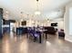 Open concept living area with hardwood floors, kitchen, dining area, and living room with ample natural light at 9677 Garamont Nw Pkwy, Concord, NC 28027