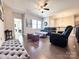 Bright loft living room featuring hardwood floors, ceiling fan and modern decor at 9677 Garamont Nw Pkwy, Concord, NC 28027