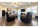Spacious living room featuring recliners, hardwood floors, and modern entertainment center at 9677 Garamont Nw Pkwy, Concord, NC 28027