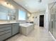 Luxury main bathroom featuring double vanity, large tub, and tiled floors at 9677 Garamont Nw Pkwy, Concord, NC 28027
