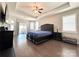 Relaxing main bedroom features trey ceiling, neutral colors and a sliding door to the outside at 9677 Garamont Nw Pkwy, Concord, NC 28027