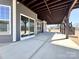 Covered patio with sliding glass door access, providing a seamless transition between indoor and outdoor living spaces at 9677 Garamont Nw Pkwy, Concord, NC 28027