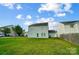 Spacious backyard featuring green grass and exterior of the house at 9704 Cayenne Dr, Charlotte, NC 28214