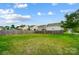 Fenced backyard with green grass and neighborhood view at 9704 Cayenne Dr, Charlotte, NC 28214