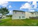 Spacious backyard featuring green grass and exterior of the house at 9704 Cayenne Dr, Charlotte, NC 28214