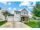 Charming two-story home with a two-car garage and well-manicured front yard at 9704 Cayenne Dr, Charlotte, NC 28214