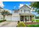 Two-story home featuring a two-car garage, stone accents, and landscaped front yard at 9704 Cayenne Dr, Charlotte, NC 28214