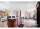Open concept kitchen with wood floors and island adjacent to dining room and living room at 9704 Cayenne Dr, Charlotte, NC 28214