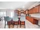 A sunlit kitchen with wood floors, stainless steel appliances, and a center island with bar stools at 9704 Cayenne Dr, Charlotte, NC 28214