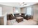 Comfortable living area featuring plush seating, ceiling fan, and natural light at 9704 Cayenne Dr, Charlotte, NC 28214