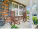 Inviting front porch with stone accents and comfortable rocking chairs at 9704 Cayenne Dr, Charlotte, NC 28214