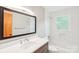 Clean bathroom featuring subway tile, white counter, and large vanity mirror at 9907 Hagers Rd, Huntersville, NC 28078