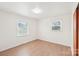 Bedroom featuring hardwood floors and two large windows providing natural light at 9907 Hagers Rd, Huntersville, NC 28078
