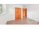 Clean bedroom with hardwood floors, and a large closet with natural light from the window at 9907 Hagers Rd, Huntersville, NC 28078