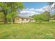 Quaint one-story home surrounded by mature trees and lush greenery, offering a serene and private setting at 9907 Hagers Rd, Huntersville, NC 28078