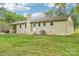 Well-maintained home exterior featuring a brick facade, chimney, and a neatly manicured lawn at 9907 Hagers Rd, Huntersville, NC 28078