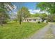 The home features a lovely exterior with a well-maintained lawn, side carport, and gravel driveway at 9907 Hagers Rd, Huntersville, NC 28078