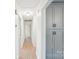 Hallway with wood-look flooring, and gray cabinet for linen and supplies storage at 9907 Hagers Rd, Huntersville, NC 28078