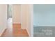 Hallway view with wood-look flooring, and bright white paint leading to additional rooms in the home at 9907 Hagers Rd, Huntersville, NC 28078