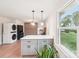 Bright kitchen features an island with a white countertop, gray cabinets, and modern pendant lighting at 9907 Hagers Rd, Huntersville, NC 28078