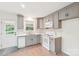 Bright kitchen with gray cabinets, white countertops, stainless steel sink, and backyard view from the window at 9907 Hagers Rd, Huntersville, NC 28078