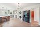 Open kitchen with island seating, modern appliances, gray cabinets, and a stacked washer-dryer at 9907 Hagers Rd, Huntersville, NC 28078
