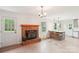 The living room includes a wood-burning fireplace, a light-filled breakfast bar, and access to the kitchen and the back yard at 9907 Hagers Rd, Huntersville, NC 28078