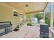 Back patio featuring a brick facade, wooden stairs, and outdoor cooking equipment at 9907 Hagers Rd, Huntersville, NC 28078