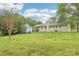 Painted brick ranch home exterior with a lush, level backyard at 9907 Hagers Rd, Huntersville, NC 28078