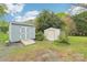 Two backyard sheds for additional storage, providing solutions for tools and equipment, set amongst grassy surroundings at 9907 Hagers Rd, Huntersville, NC 28078