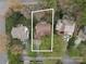 Aerial view of a home highlighting its location within a neighborhood and the approximate property lines; mature trees abound at 108 Kinderston Dr, Davidson, NC 28036