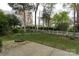 Spacious backyard featuring a well-kept lawn, a stone fire pit, white picket fence, and lush greenery, perfect for outdoor at 108 Kinderston Dr, Davidson, NC 28036