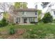 Back of house featuring a well-maintained lawn, a patio for outdoor seating and entertainment, and lush landscaping at 108 Kinderston Dr, Davidson, NC 28036
