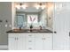 Bathroom with double vanity, copper sinks, white cabinets, and stylish fixtures, creating a modern and inviting space at 108 Kinderston Dr, Davidson, NC 28036