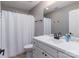Well-lit bathroom featuring a white vanity and shower with a white shower curtain at 108 Kinderston Dr, Davidson, NC 28036