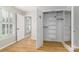 Bedroom featuring wood laminate flooring, and a closet and window fitted with white shutters at 108 Kinderston Dr, Davidson, NC 28036
