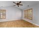 Bedroom featuring vaulted ceilings, wood laminate flooring, and a window fitted with brown shutters at 108 Kinderston Dr, Davidson, NC 28036