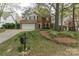 Charming two-story brick home with a well-manicured front yard and an attached two-car garage at 108 Kinderston Dr, Davidson, NC 28036