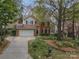 Charming two-story brick home with a well-manicured front yard and an attached two-car garage at 108 Kinderston Dr, Davidson, NC 28036