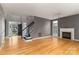 Entryway featuring hardwood floors, a staircase and view to the living room with fireplace at 108 Kinderston Dr, Davidson, NC 28036