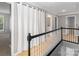 Hallway with white curtain divider, gray walls, and hardwood floors at 108 Kinderston Dr, Davidson, NC 28036