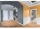 Hallway featuring hardwood floors, gray and yellow walls, staircase, and arched doorways at 108 Kinderston Dr, Davidson, NC 28036