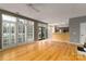 Open-concept living room with hardwood floors, fireplace and adjoining kitchen area at 108 Kinderston Dr, Davidson, NC 28036