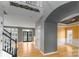 Open living room featuring hardwood floors, gray walls, staircase, and arched doorways at 108 Kinderston Dr, Davidson, NC 28036