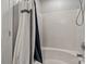 This bathroom features a white shower/tub combination with stylish curtain and showerhead at 10920 Walking Path Ln, Charlotte, NC 28213