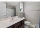 Well-lit bathroom features a modern sink, toilet and shower with updated fixtures at 10920 Walking Path Ln, Charlotte, NC 28213